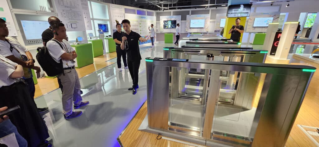 ZKTeco representative demonstrating advanced turnstile solutions to a group, highlighting the features and functionality of ZKTeco's access control systems.