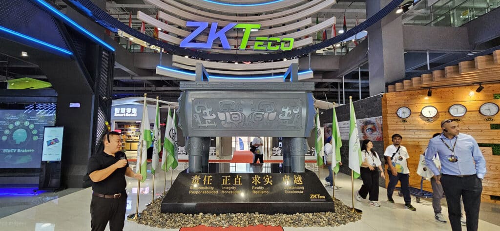 Display of ZKTeco’s core values, including Responsibility, Integrity, Reality, and Excellence, in a grand area at the Experience Centre, with visitors engaged in the exhibits.