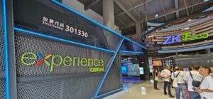 Entrance to ZKTeco Experience Centre, featuring a modern design with illuminated signage and visitors exploring various technology displays.