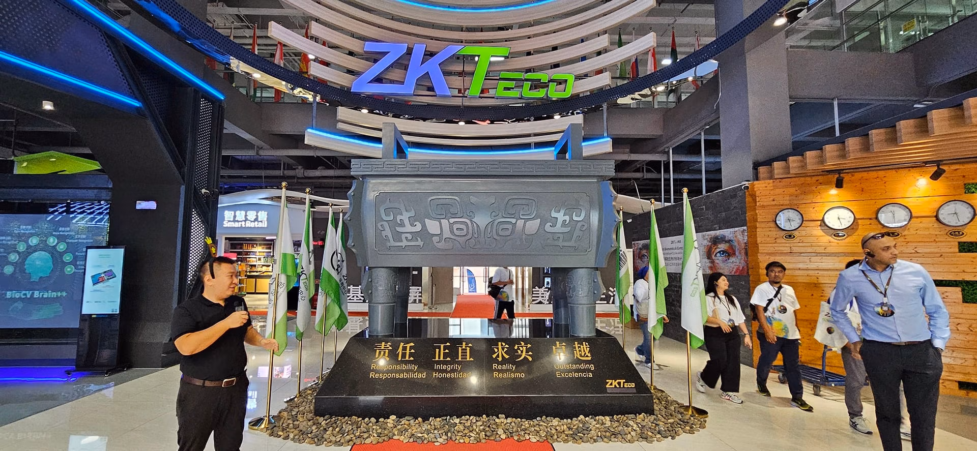 Display of ZKTeco’s core values, including Responsibility, Integrity, Reality, and Excellence, in a grand area at the Experience Centre, with visitors engaged in the exhibits.