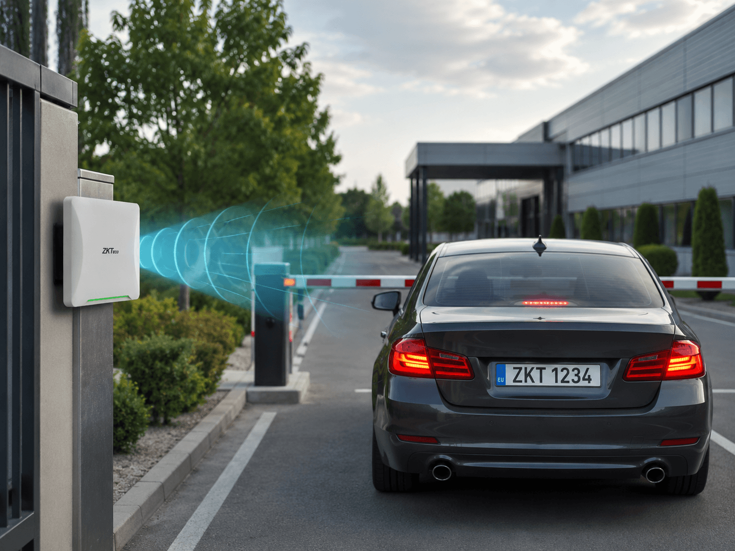 ZKTeco UHF vehicle reader scanning a car at an automatic barrier gate for contactless vehicle access control.